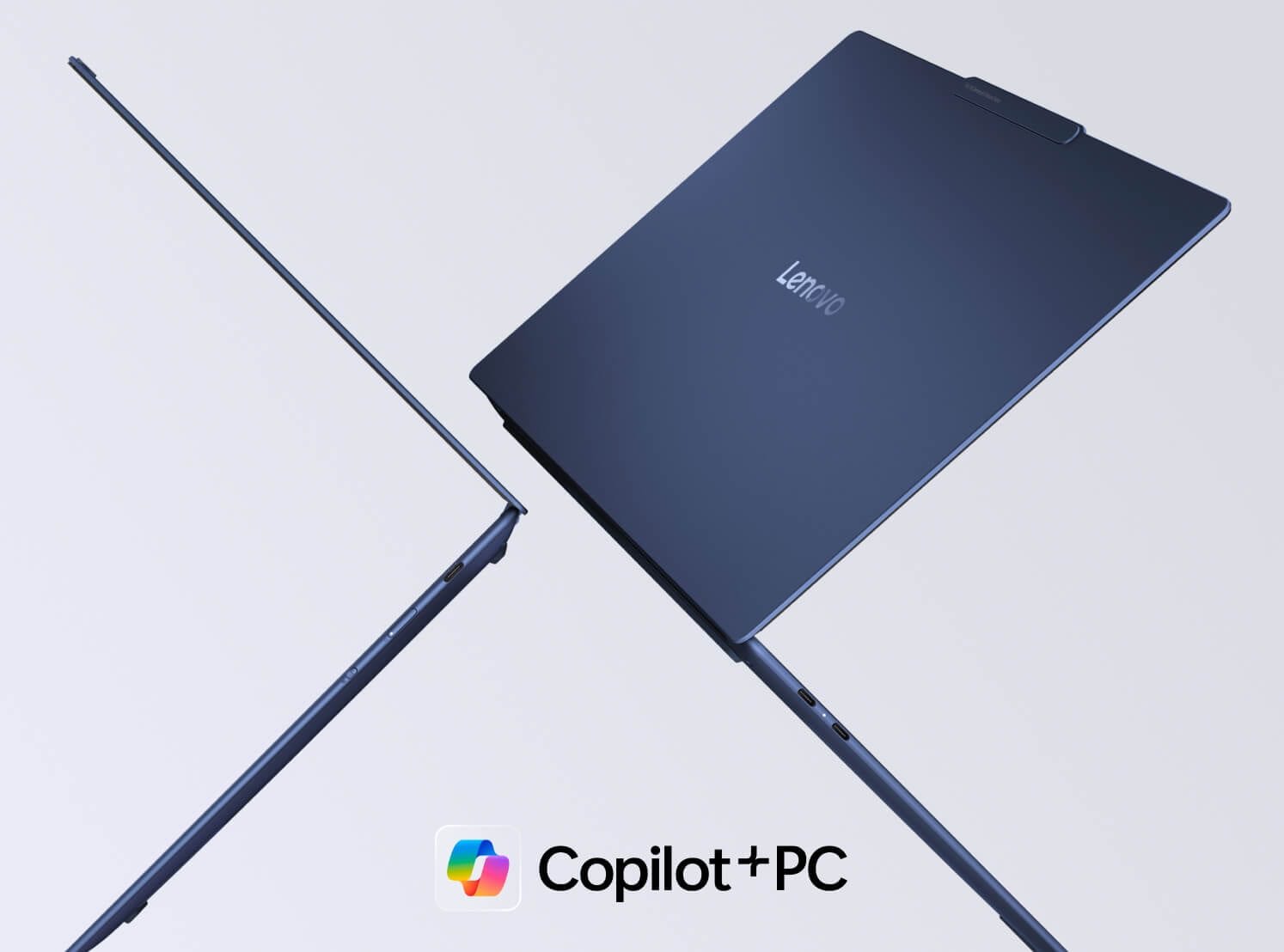 Dos portátiles Lenovo Yoga flotando en el aire uno contra otro con el logotipo de Copilot